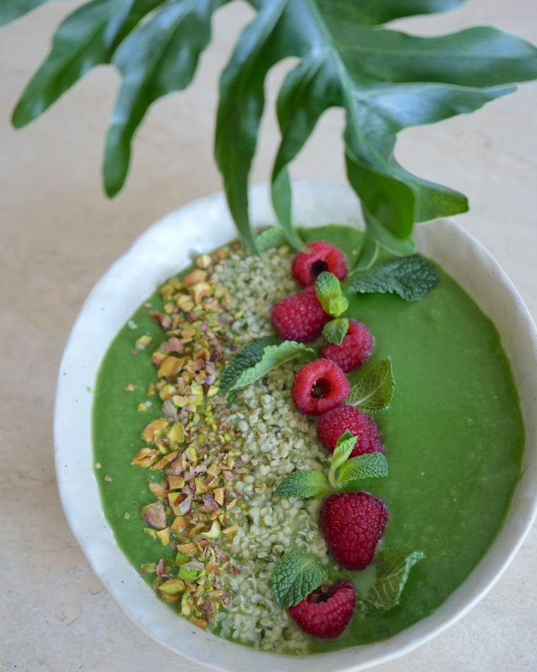 Green smoothie bowl with raspberries