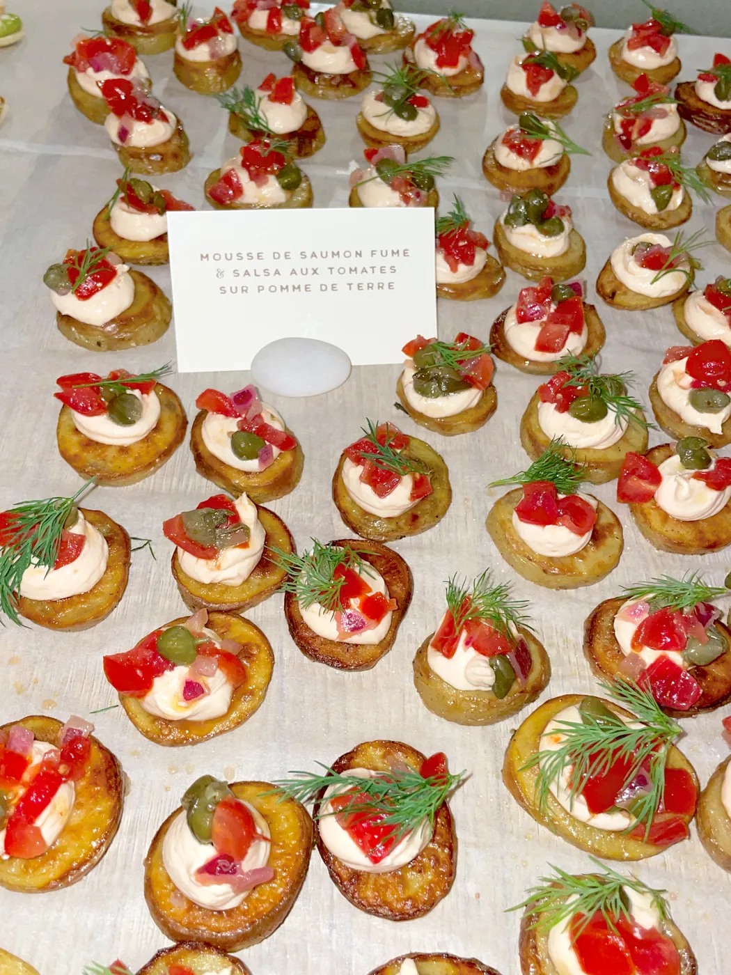 Smoked salmon mousse with tomato salsa on potato slices