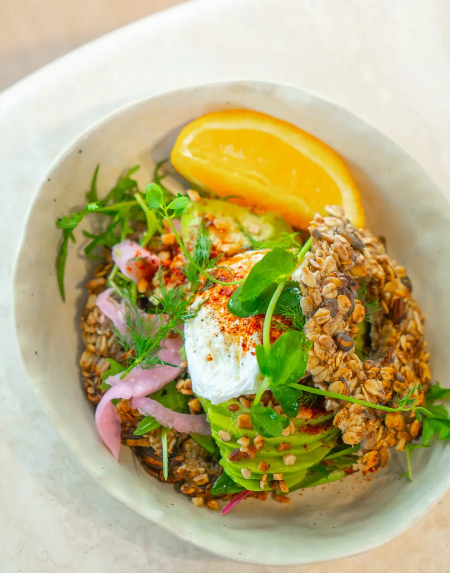 A vibrant grain bowl beside a green drink