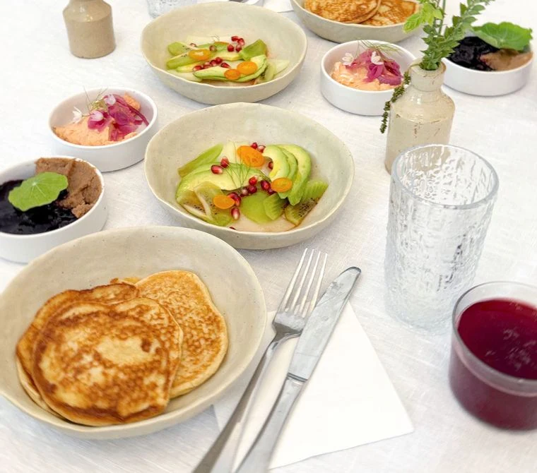 A healthy breakfast of pancakes, fruit salads and fresh juice