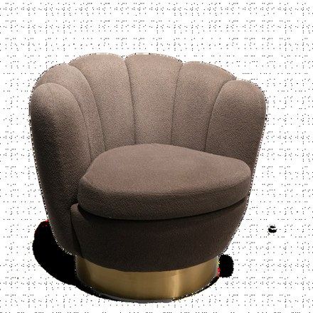 A scalloped armchair on a brass base